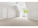 Clean, carpeted bedroom with a window seat and natural lighting at 3513 Forest Oaks Dr, Chapel Hill, NC 27514