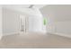 An open bedroom with neutral carpet, white walls, ensuite and a window for natural light at 3513 Forest Oaks Dr, Chapel Hill, NC 27514