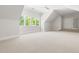 Spacious bonus room with carpet, natural lighting and a staircase at 3513 Forest Oaks Dr, Chapel Hill, NC 27514
