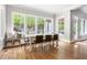 Dining room with a wooden floor, a large dining table, big windows and a built-in window bench at 3513 Forest Oaks Dr, Chapel Hill, NC 27514
