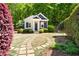 Charming exterior of a detached building with stone pathway and lush landscaping at 3513 Forest Oaks Dr, Chapel Hill, NC 27514