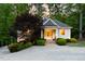 Exterior of a detached building with stone accents, mature landscaping, and a lit entry at 3513 Forest Oaks Dr, Chapel Hill, NC 27514