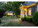 Inviting exterior of a home and a detached building with landscape lighting and stone pathway at 3513 Forest Oaks Dr, Chapel Hill, NC 27514