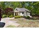 Detached building surrounded by mature landscaping, accessed by a long concrete driveway at 3513 Forest Oaks Dr, Chapel Hill, NC 27514