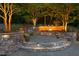 Beautiful outdoor fire pit area with stone surround and ambient lighting, perfect for entertaining at 3513 Forest Oaks Dr, Chapel Hill, NC 27514