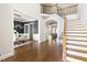 Spacious foyer with hardwood floors, a staircase with iron railings, and an archway to the dining and living spaces at 3513 Forest Oaks Dr, Chapel Hill, NC 27514