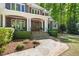 Elegant home featuring a stone pathway leading to a welcoming front porch with stately columns and wood doors at 3513 Forest Oaks Dr, Chapel Hill, NC 27514