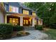 Beautiful home with a stone pathway leading to the front porch, showing architectural details and lighting at 3513 Forest Oaks Dr, Chapel Hill, NC 27514