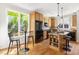 Kitchen features an island, black appliances, breakfast bar, and hardwood floors at 3513 Forest Oaks Dr, Chapel Hill, NC 27514