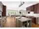 Modern kitchen with a spacious island, granite countertops, dark wood cabinetry, and stainless steel appliances at 3513 Forest Oaks Dr, Chapel Hill, NC 27514