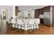Kitchen island with granite countertops and seating, showcasing a modern design and hardwood floors at 3513 Forest Oaks Dr, Chapel Hill, NC 27514