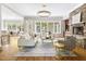 Open living room with stone fireplace, hardwood floors, and large windows at 3513 Forest Oaks Dr, Chapel Hill, NC 27514