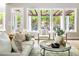Bright living room featuring a comfortable couch, elegant decor, and a view of the outdoor pergola at 3513 Forest Oaks Dr, Chapel Hill, NC 27514