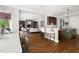 Open floorplan showcasing hardwood floors, a modern kitchen, and a cozy living area with a stone fireplace at 3513 Forest Oaks Dr, Chapel Hill, NC 27514