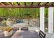 Cozy patio area with a view of the stone fire pit and lush greenery, creating a serene outdoor space at 3513 Forest Oaks Dr, Chapel Hill, NC 27514