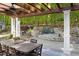 Inviting outdoor patio features a dining table, pergola, and a stone fire pit, perfect for relaxing at 3513 Forest Oaks Dr, Chapel Hill, NC 27514