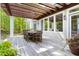 Spacious outdoor dining area on a wooden deck with pergola and serene backyard views at 3513 Forest Oaks Dr, Chapel Hill, NC 27514