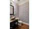 Stylish powder room showcasing a unique vessel sink, modern fixtures, and patterned wallpaper at 3513 Forest Oaks Dr, Chapel Hill, NC 27514