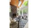 Bright sunroom with a stone fireplace, comfortable seating, and large windows offering scenic views of nature at 3513 Forest Oaks Dr, Chapel Hill, NC 27514