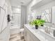 Modern bathroom with double sinks, stylish fixtures, and a bathtub-shower combination at 3813 Rosebush Dr, Zebulon, NC 27597