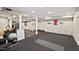 Basement transformed into a home gym featuring exercise equipment and rubber flooring at 3826 Regent Rd, Durham, NC 27707