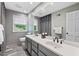 Modern bathroom with double sinks, a large mirror, and sleek tile flooring at 3826 Regent Rd, Durham, NC 27707