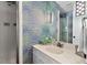 Charming bathroom with patterned wallpaper, modern vanity, and shower stall at 3826 Regent Rd, Durham, NC 27707