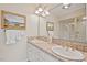 Well-lit bathroom with double sinks, tile countertop, a large mirror, and a shower at 3826 Regent Rd, Durham, NC 27707