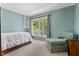 Bright bedroom features a large window and an inviting, comfortable armchair at 3826 Regent Rd, Durham, NC 27707