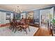 Elegant dining room with hardwood floors, area rug, chandelier, and classic furnishings at 3826 Regent Rd, Durham, NC 27707