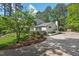 Beautiful home exterior with well-manicured landscaping and a long driveway at 3826 Regent Rd, Durham, NC 27707