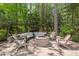 Cozy backyard fire pit area with comfortable seating surrounded by mature trees at 3826 Regent Rd, Durham, NC 27707