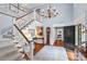 Grand foyer with high ceilings, elegant staircase, hardwood floors, and stylish chandelier at 3826 Regent Rd, Durham, NC 27707
