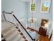 Grand foyer featuring hardwood floors, chandelier, and staircase with white banister at 3826 Regent Rd, Durham, NC 27707