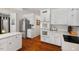 Spacious kitchen featuring white cabinets, hardwood floors, and modern appliances at 3826 Regent Rd, Durham, NC 27707