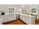 Well-lit kitchen with white cabinets, stainless steel appliances, and a window view at 3826 Regent Rd, Durham, NC 27707