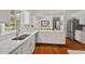 Bright kitchen with white cabinetry, stainless steel appliances, and hardwood floors at 3826 Regent Rd, Durham, NC 27707