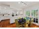 Eat-in kitchen with white cabinets, stainless steel appliances, hardwood floors and table at 3826 Regent Rd, Durham, NC 27707