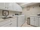 Well-lit laundry room with ample counter space, a sink, and modern washer and dryer at 3826 Regent Rd, Durham, NC 27707