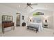 Bright main bedroom featuring a window with natural light, white walls, and a seating area at 3826 Regent Rd, Durham, NC 27707