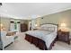 Inviting main bedroom with carpet, large bed, sitting area, and plenty of natural light at 3826 Regent Rd, Durham, NC 27707