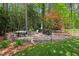 Paver patio with outdoor seating and stone firepit at 3826 Regent Rd, Durham, NC 27707