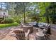 Paver patio with outdoor seating and a stone fire pit at 3826 Regent Rd, Durham, NC 27707