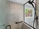 Luxurious walk-in shower with marble tiles and window offering natural light at 3826 Regent Rd, Durham, NC 27707