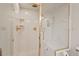 Modern shower featuring gold trim, a built-in bench, and a handheld shower head at 3826 Regent Rd, Durham, NC 27707