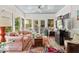 Light-filled sunroom with comfortable seating and views of the lush backyard at 3826 Regent Rd, Durham, NC 27707