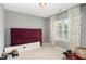 Cozy bedroom with neutral walls, a large window, and a plush headboard; perfect for relaxation at 406 Sapphire Dr, Durham, NC 27703