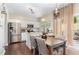 Bright kitchen with white cabinets and adjacent dining area with backyard access at 406 Sapphire Dr, Durham, NC 27703