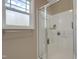 Bright bathroom featuring a shower with glass doors and convenient storage shelves at 42 Voyage Cir, Smithfield, NC 27577