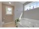 Bathroom featuring a soaking tub, shower, and natural light from a large window at 42 Voyage Cir, Smithfield, NC 27577